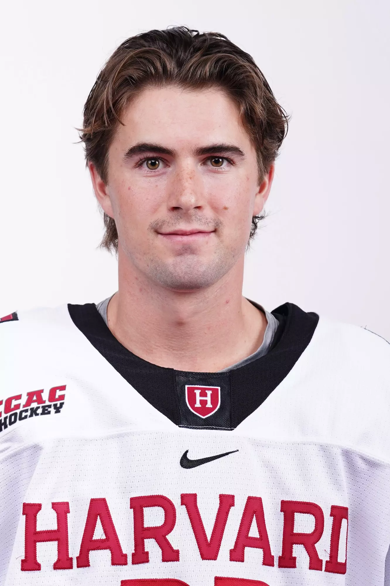 Kyle Aucoin wearing his Harvard hockey jersey