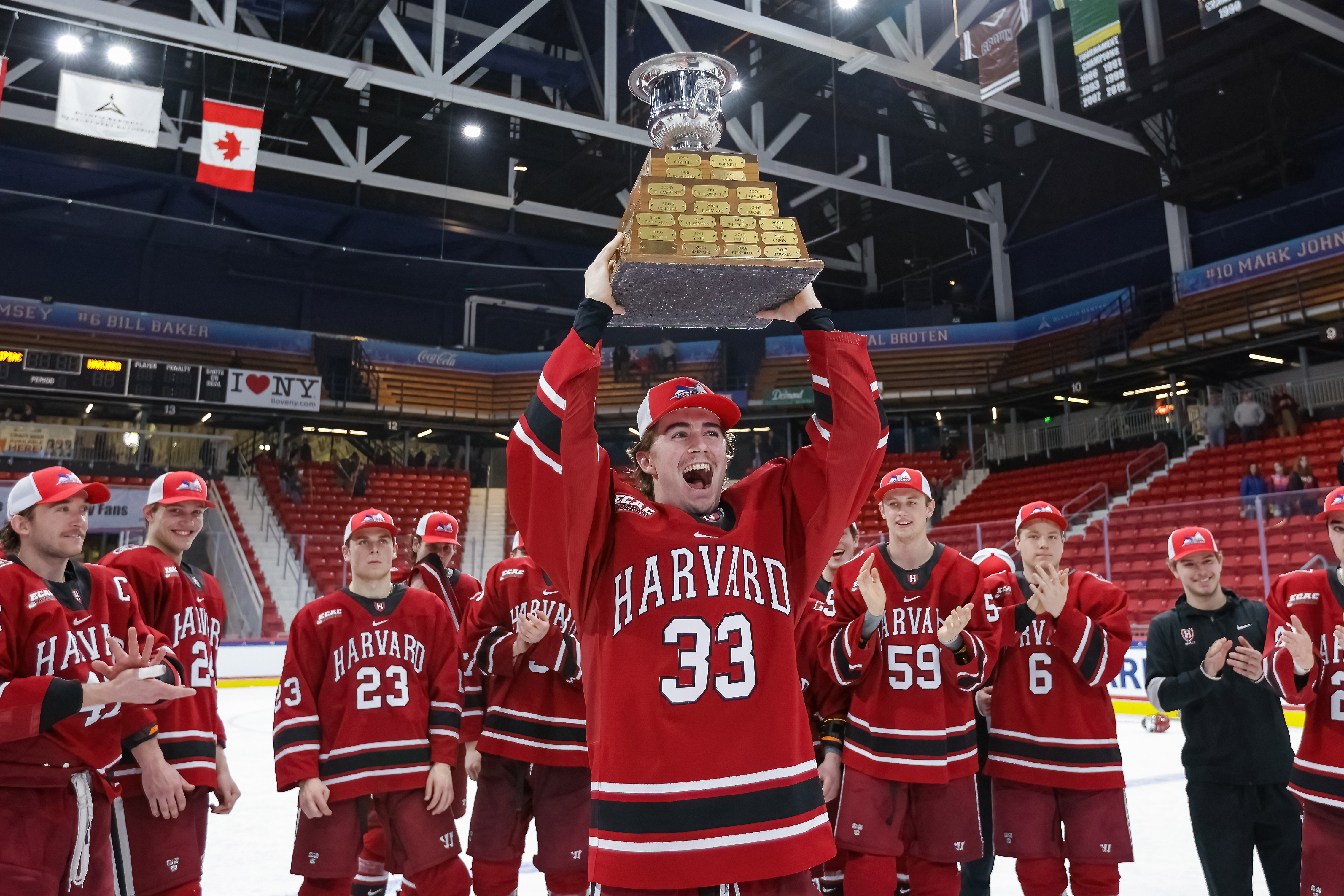 Kyle lifting a trophy with Harvard hockey